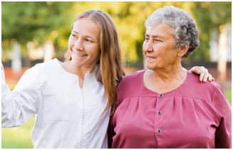 caregiver and senior woman smiling