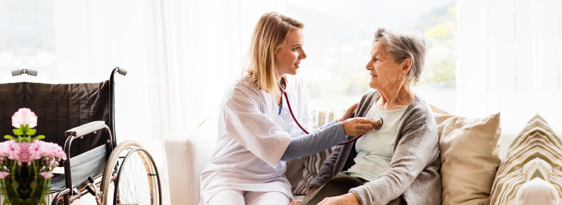 senior woman and nurse with stethoscope