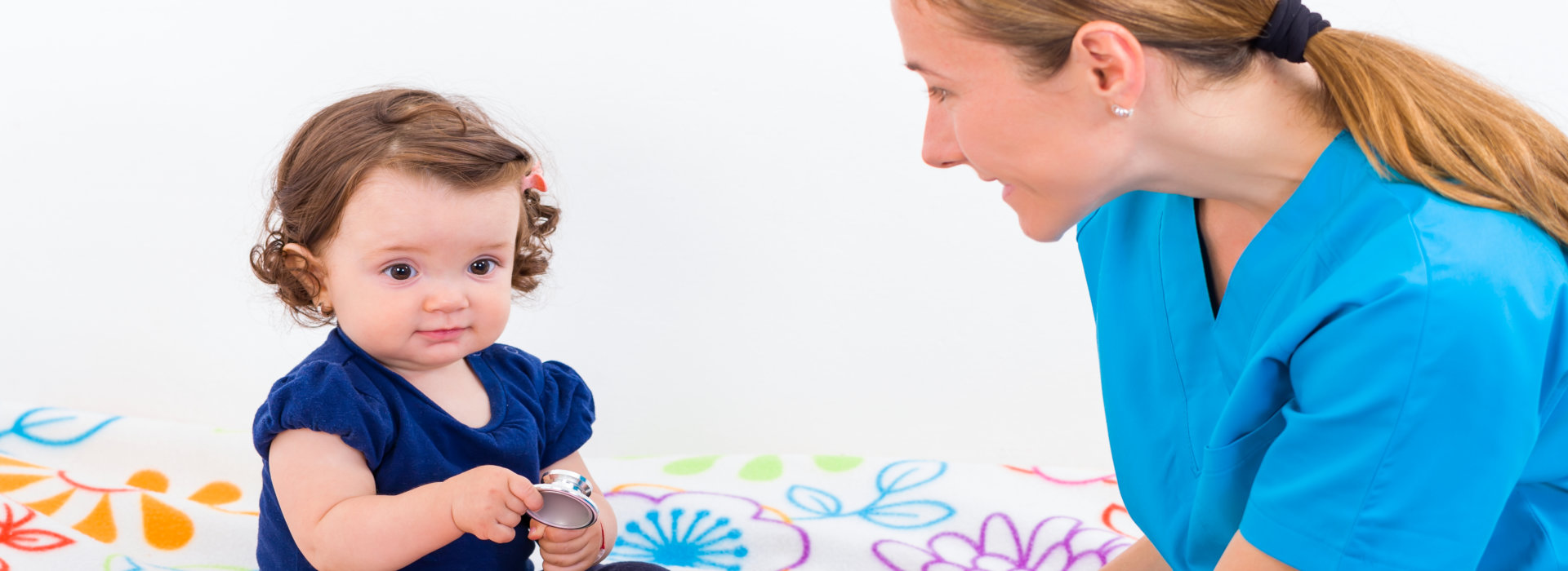 nurse playing with baby girl