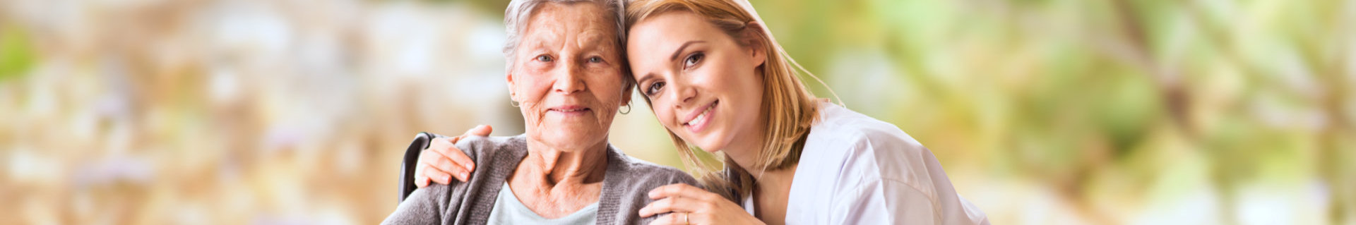 caregiver and senior woman smiling