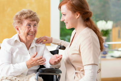 caregiver and senior woman smiling