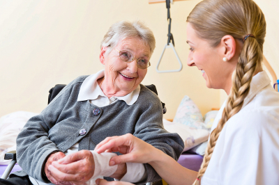 caregiver and senior woman smiling